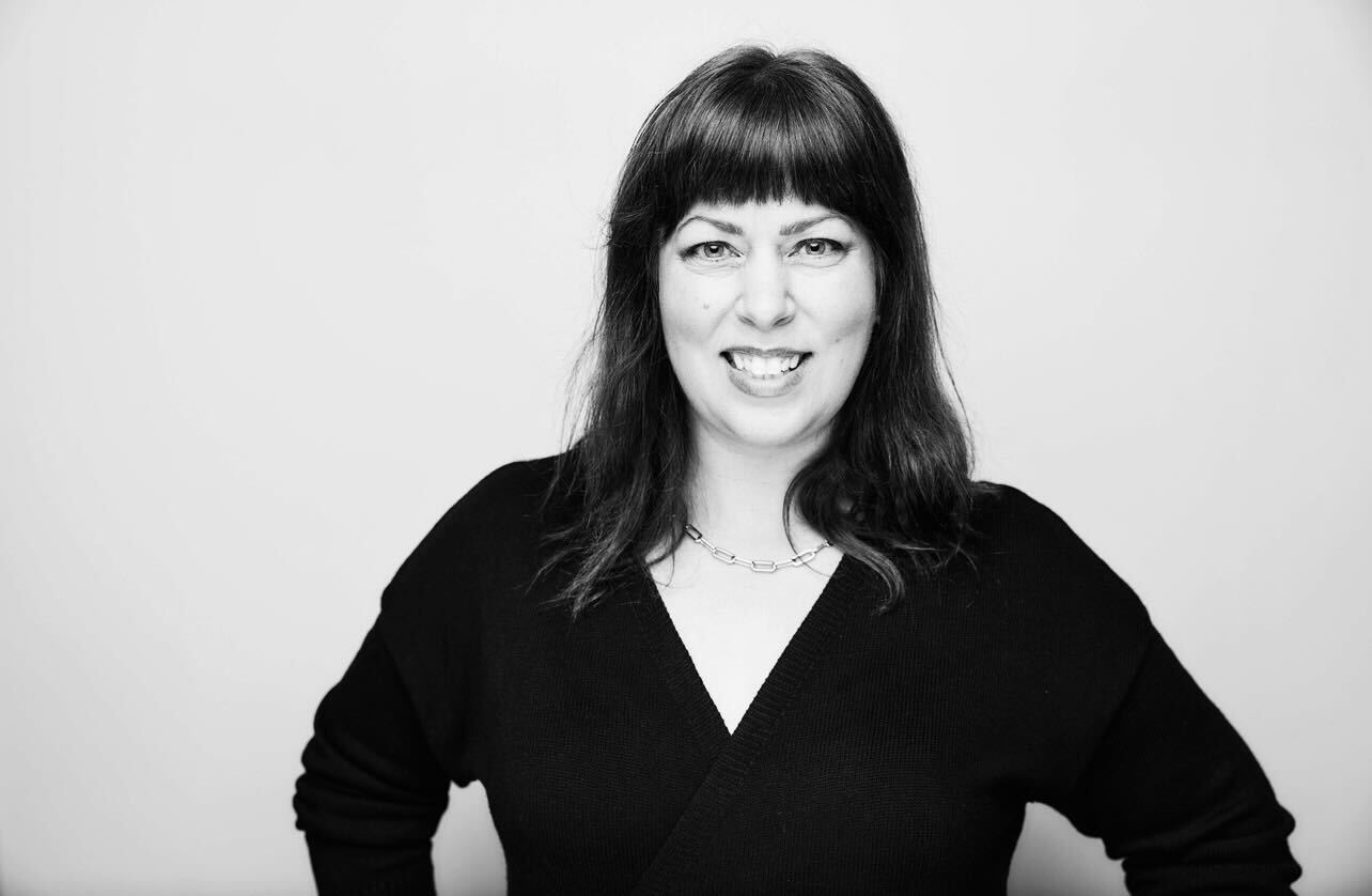 A black and white photo of a woman smiling