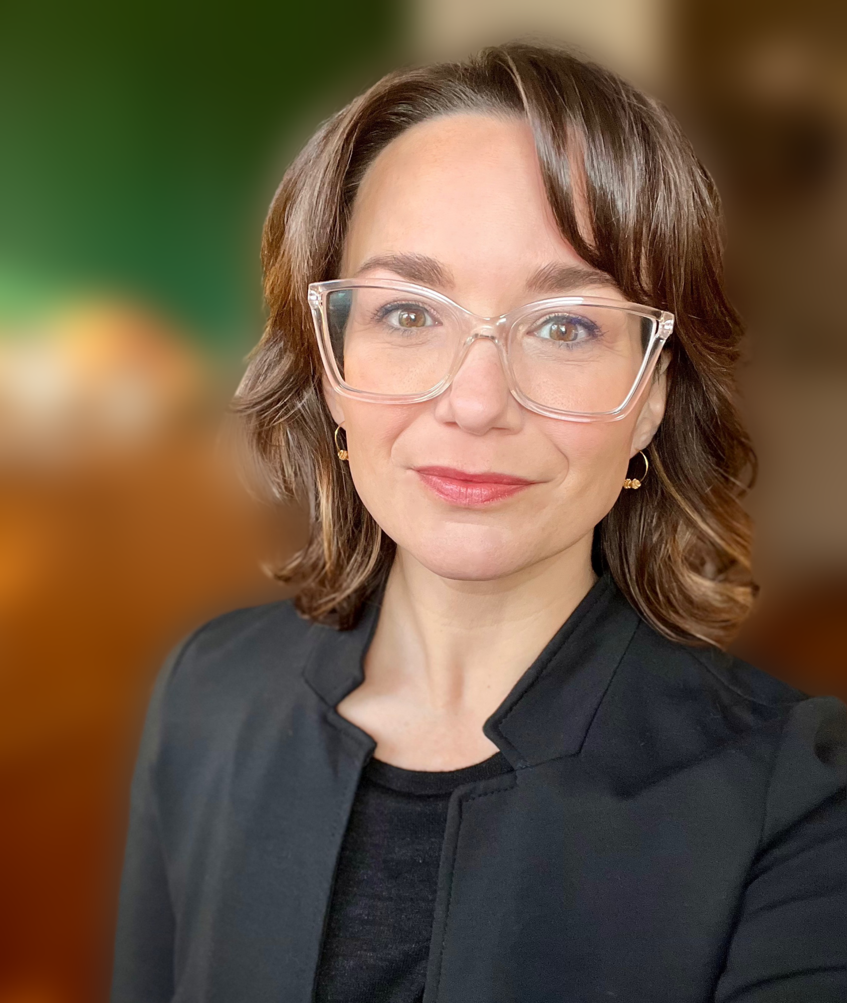 a woman with short brown hair and glasses